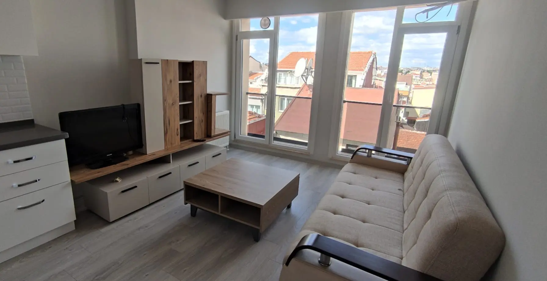 Fully furnished and modern living room with stylish decor and comfortable seating in a Kurtuluş apartment, Istanbul.