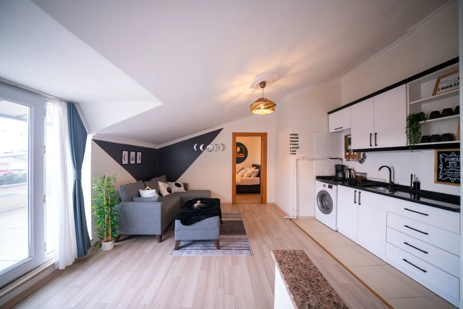 Spacious and modern duplex living area with high ceilings and contemporary decor in a Beyoğlu residence, Istanbul.