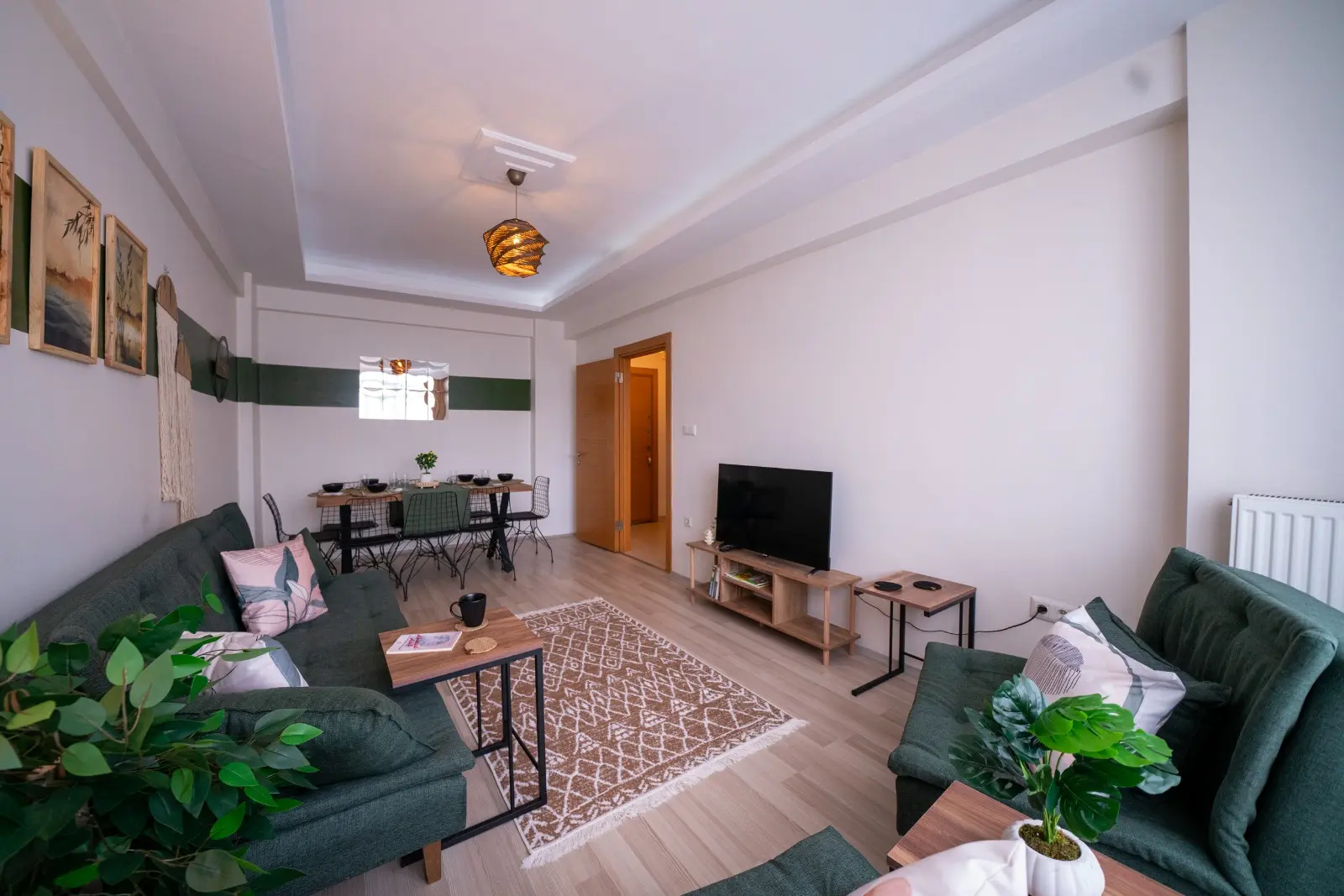 Bright and modern living room featuring large windows with a panoramic city view in a Beyoğlu apartment, Istanbul.