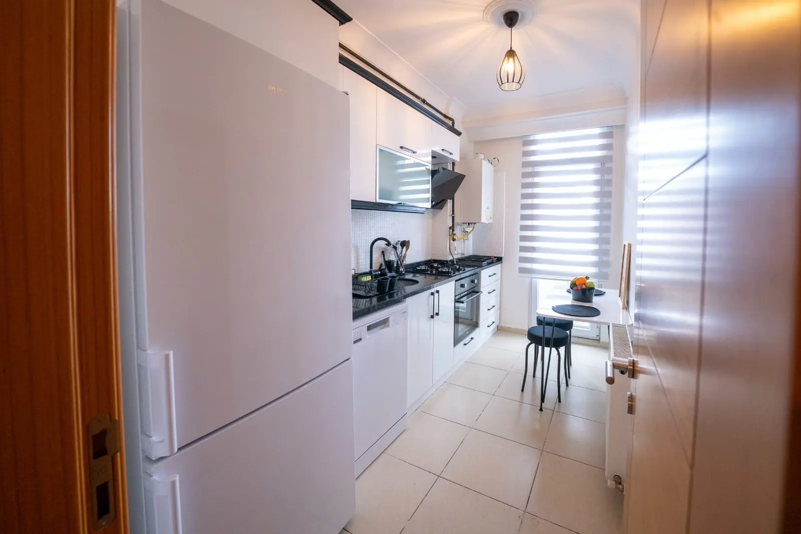 Modern kitchen design with sleek cabinetry and contemporary interior finishes in a Beyoğlu apartment, Istanbul.