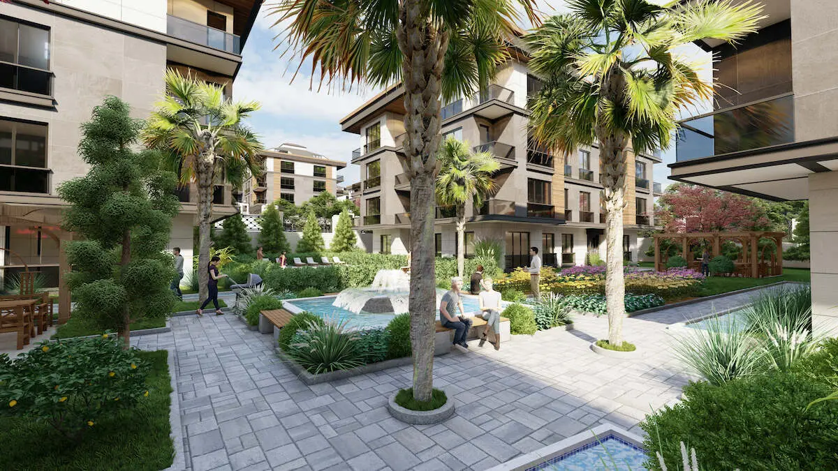 Exterior view of a luxury residential building with a beautifully landscaped green garden in Beylikdüzü, Istanbul.